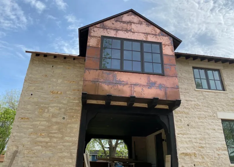 Copper metal panel facade on a stone building for Skylight Installation in Tolland